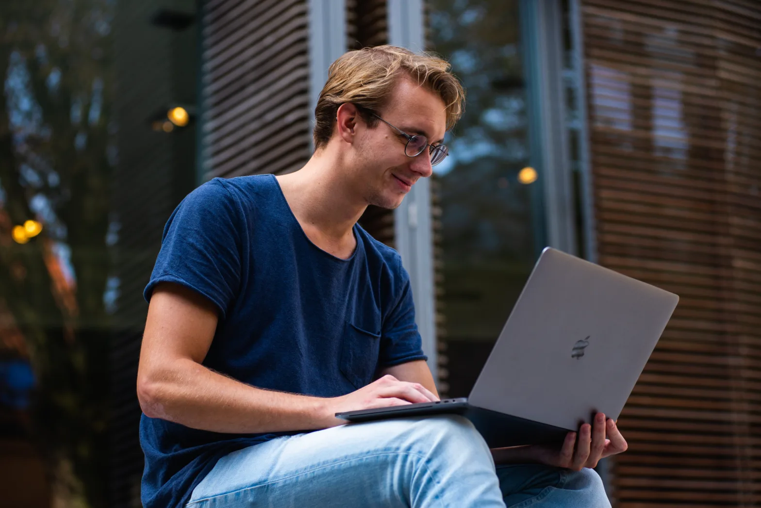 Male on laptop outside