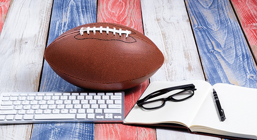 Football next to keyboard and office items