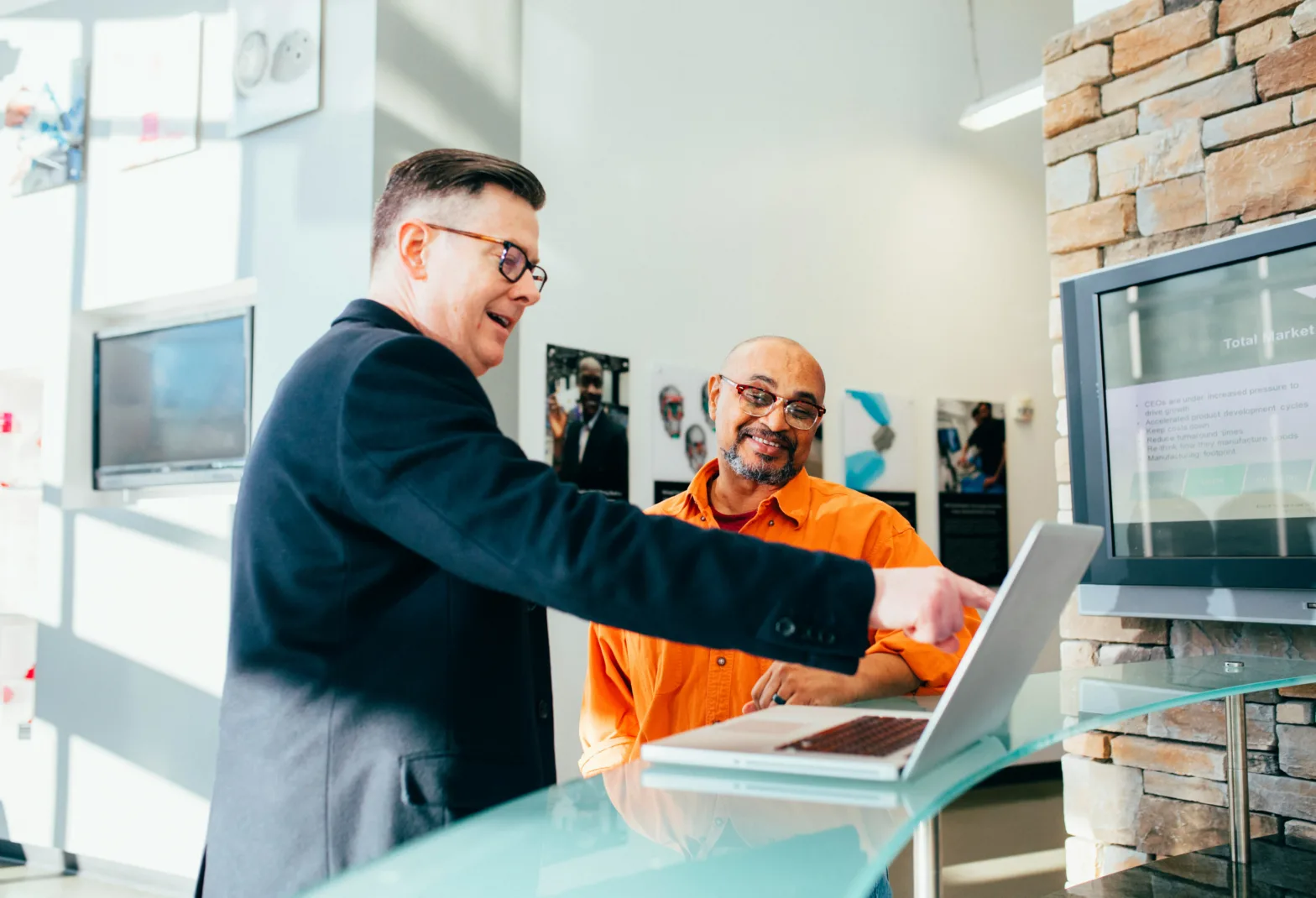 Solutions partner talking with client with a laptop