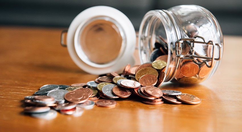 coins in a jar spilled out on table