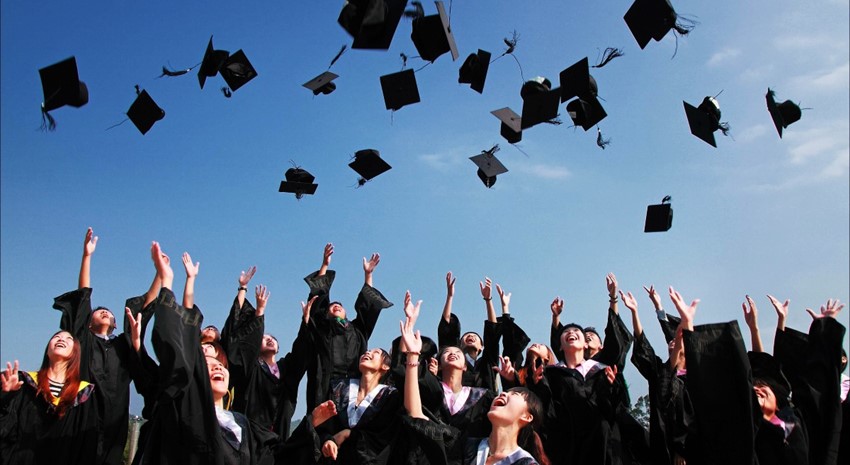 College graduates throwing hats