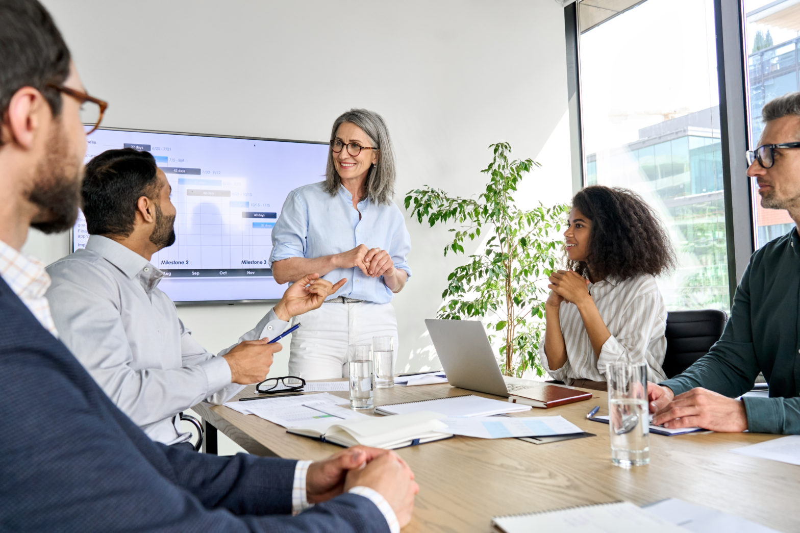 Employees having a discussion and presentation in boardroom