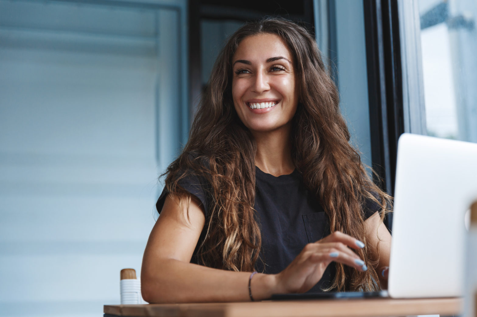 Happy business woman smiling on her laptop