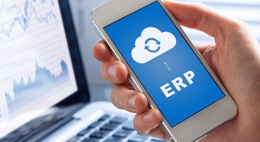 Cloud ERP depicted on smartphone at computer desk