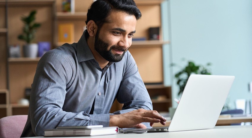 Man on computer smiling