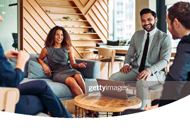 Group of business coworkers smiling and having a conversation at a casual spot in their office