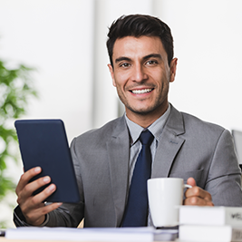 handsome caucasian businessman holding tablet computer
