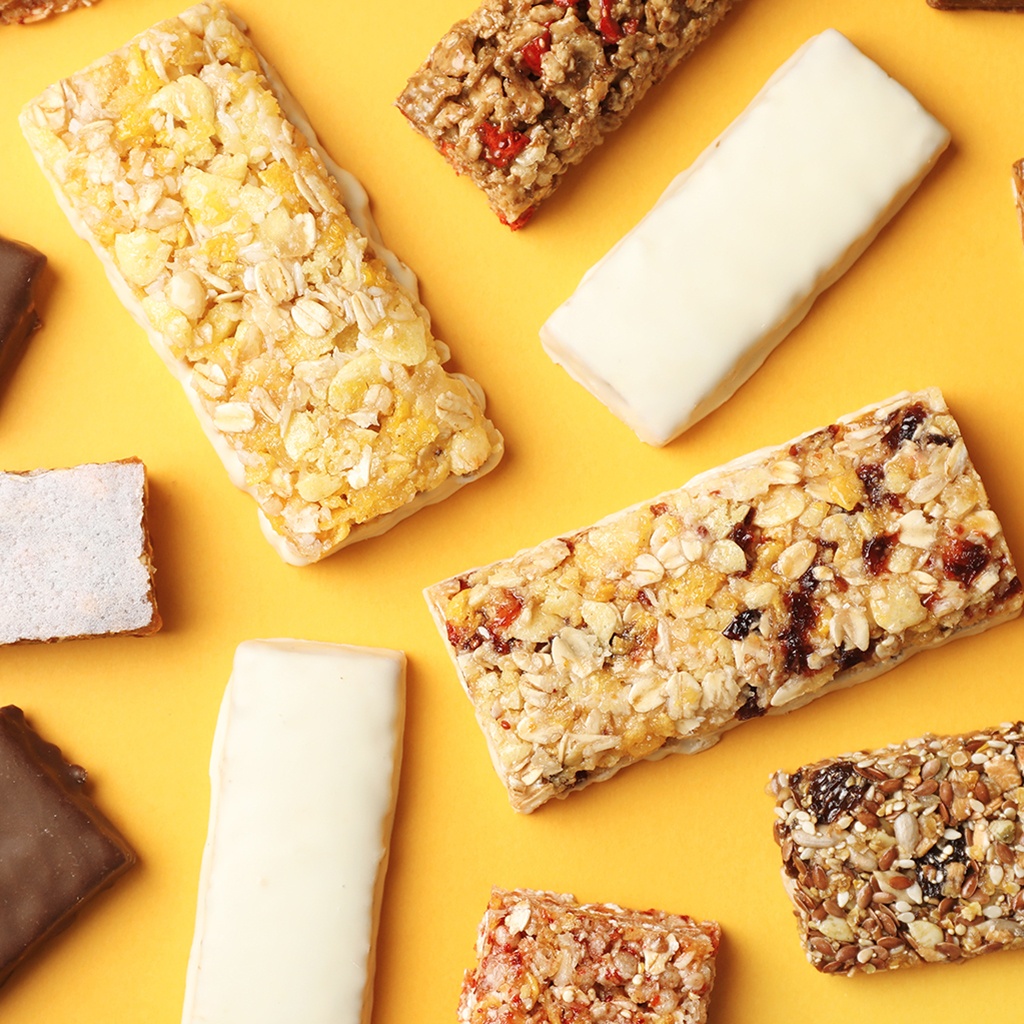 Granola bars laid out over a orange backdrop