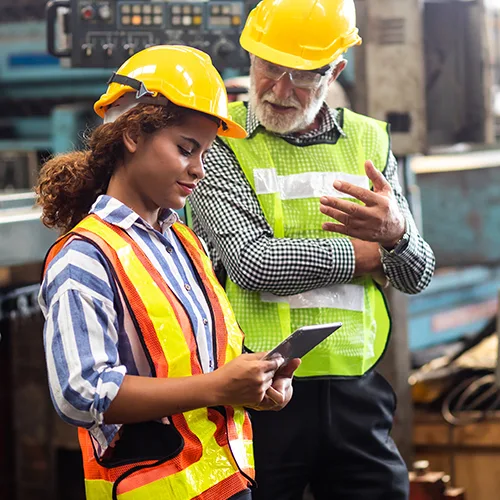 Two warehouse employees looking at a tablet