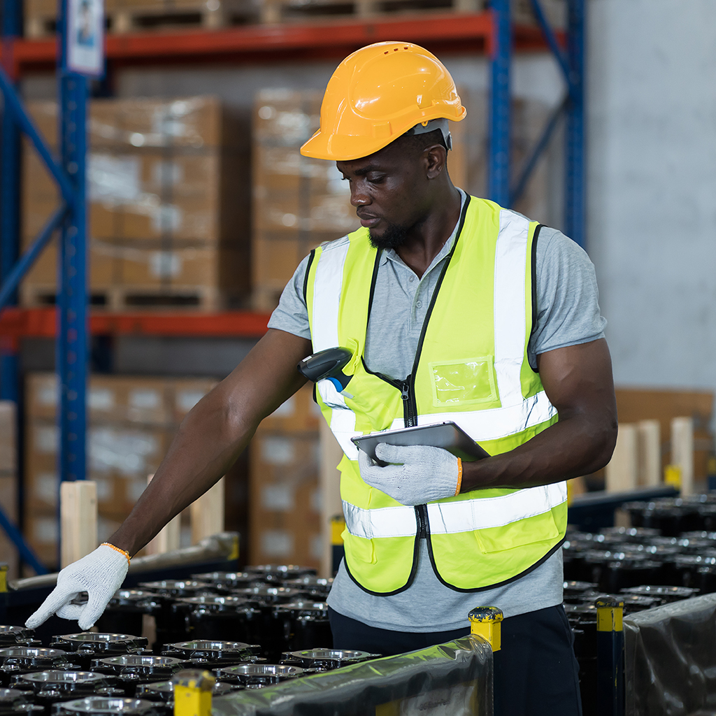 Worker in manufacturing holding a tablet