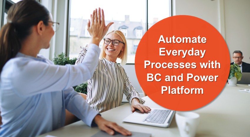 two office workers high-fiving over laptops