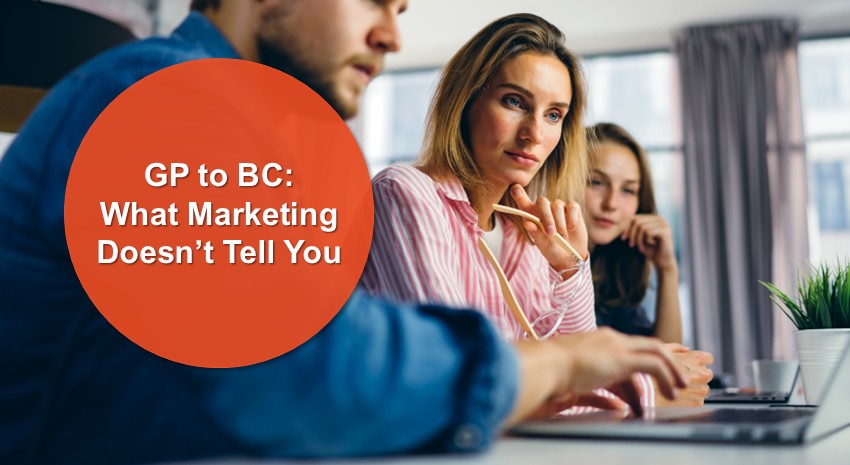 office workers looking over a shared laptop